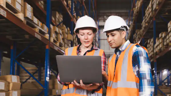 Coworkers reviewing inventory in the warehouse